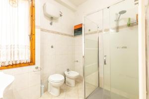 a bathroom with a toilet and a glass shower at Holiday House Giuliana in Poggio a Caiano +27 photos