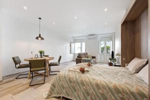 a bedroom with a large bed and a dining room at Villa Xique 11 in Monchique