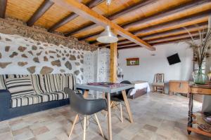 a living room with a table and a couch at Estudio Pu in La Vegueta +13 photos
