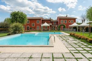 a swimming pool in front of a house at Casolare dei Fiori - Calla in Montecarlo