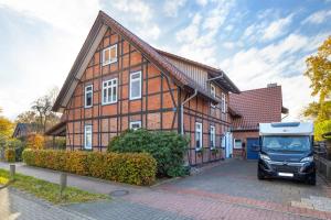 a van parked in front of a house at Ferienwohnung Örtzetal in Hermannsburg