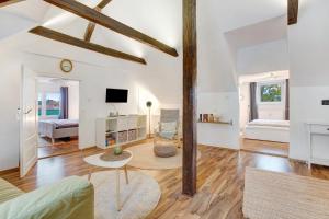 a living room with white walls and wooden beams at Ferienwohnung Örtzetal in Hermannsburg