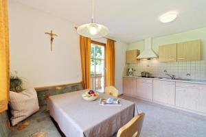 a kitchen with a table with a bowl of fruit on it at Leitnerhof in Racines +16 photos