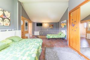 a bedroom with a bed and a crib at El Berrueco in El Berrueco +24 photos