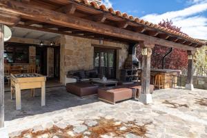 an outdoor patio with a table and a pool table at El Berrueco in El Berrueco