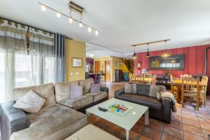 a living room with a couch and a table at El Berrueco in El Berrueco
