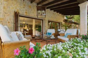a living room with chairs and a table and flowers at Font in Mancor del Valle