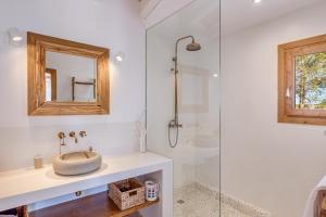 a bathroom with a sink and a glass shower at Sa Vinya Jove in Biniali +20 photos