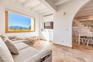 a living room with a couch and a staircase at Sa Vinya Jove in Biniali
