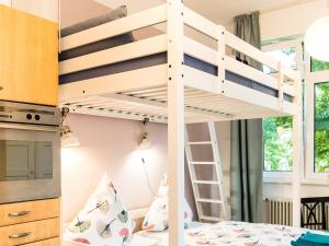 a bunk bed in a bedroom with a bunk bed in a room at Apartment Am Birnbaum in Reutlingen +7 photos