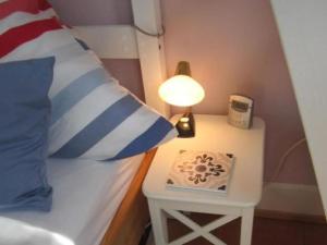 a bed with a side table with a lamp on it at Apartment Am Birnbaum in Reutlingen