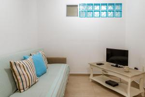 a living room with a couch and a table at Afroditi Ftelia Yasemi b in Mykonos
