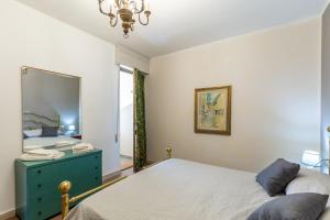 a bedroom with a bed and a mirror at Residence Caravel 9 in Lido di Camaiore