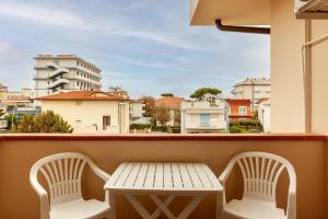 a table and chairs on a balcony with a view at Residence Caravel 9 in Lido di Camaiore