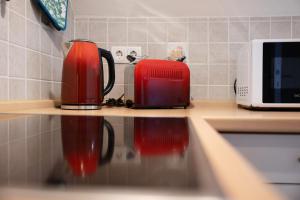 a kitchen counter with two coffee pots and a microwave at Ferienwohnung Abendsonne in Lehe