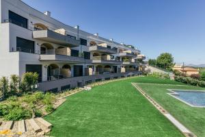 an apartment building with a lawn in front of it at Bonavista Begur in Begur