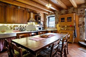 a kitchen with a wooden table in a room at Baita Chalet Alabama in Arsiè +27 photos