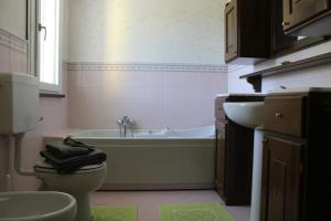 a bathroom with a tub and a toilet and a sink at Relax and apartment in SantʼAgata Feltria