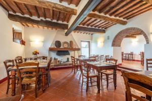 a large dining room with wooden tables and chairs at Agriturismo la Taverna Di Celsa in Sovicille