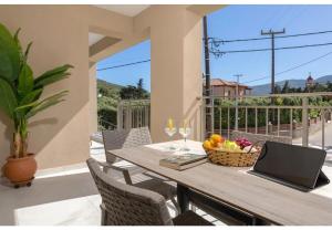 a table with a laptop on top of a balcony at Villa Zografia in Alikanas