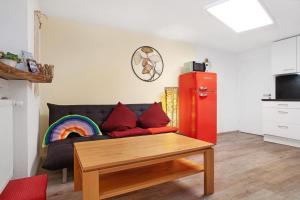 a living room with a couch and a rainbow at Carpe Diem in Altshausen