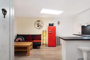 a living room with a red refrigerator and a couch at Carpe Diem in Altshausen +22 photos