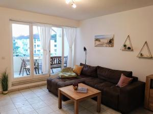 a living room with a couch and a table at Ostseeperle Karlina in Karlshagen