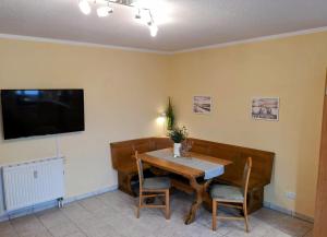 a dining room with a table and a tv at Ostseeperle Karlina in Karlshagen