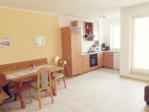 a kitchen and dining room with a table and chairs at Ostseeperle Karlina in Karlshagen +12 photos