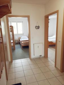a room with a bedroom with a bed and a mirror at Ostseeperle Karlina in Karlshagen