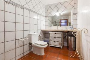 a bathroom with a white toilet and a sink at Maresme Natura in Sant Iscle de Vallalta +12 photos