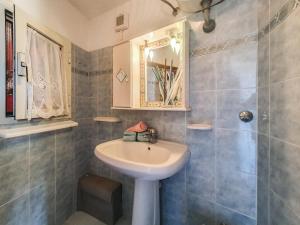 a bathroom with a sink and a mirror and a shower at Appartamento Anita in Capoliveri +12 photos