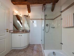 a bathroom with a shower and a sink and a tub at Ferienwohnungen Hensler in Lindau +27 photos