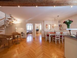 a living room and dining room with a table and chairs at Ferienwohnungen Hensler in Lindau