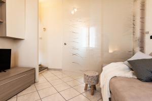 a bedroom with a bed and a tv in a room at Appartamento Anita in Capoliveri