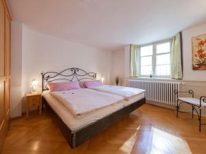 a bedroom with a large bed and a window at Ferienwohnungen Hensler in Lindau
