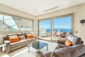 a living room with couches and a view of the ocean at Stunning Casa Bella Vista in Adeje