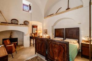 a bedroom with a bed and a desk at Antica corte dell'800 in Castrignano del Capo