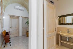 a bathroom with a sink and a mirror at Antica corte dell'800 in Castrignano del Capo +21 photos