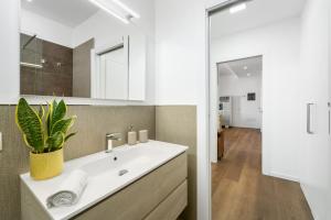 a bathroom with a sink and a mirror at 4 Seasons Apartment in Guspini +19 photos