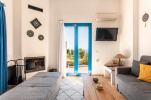 a living room with a couch and a fireplace at Villa Kalliope in Gennadi