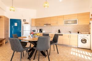 a kitchen with a dining room table and chairs at Villa Kalliope in Gennadi