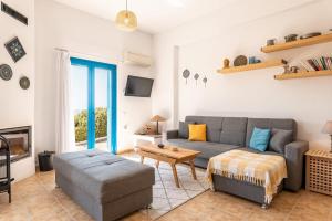 a living room with a couch and a table at Villa Kalliope in Gennadi