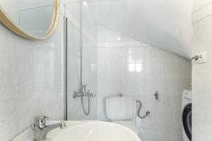 a bathroom with a toilet and a sink and a mirror at Olympos Blue in Karpathos +26 photos