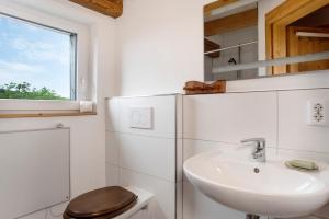 a bathroom with a sink and a white refrigerator at Hof Sinnenberg in Deggenhausertal +60 photos