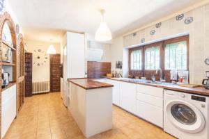 a kitchen with a washer and dryer at Casa Rural Las Yernas in La Serrada