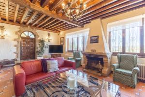 a living room with a couch and chairs and a fireplace at Casa Rural Las Yernas in La Serrada