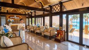 a woman standing in a room with a row of chairs at Silver Beach Resort Ke Ga in Ke Ga