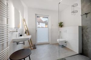 a bathroom with a sink and a toilet at Ferienwohnung an der Gustavsburg in Homburg +13 photos