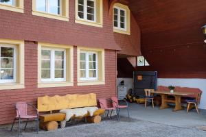 a building with a table and chairs and a bench at Alte Schmiede in Feldberg